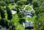 far hills country mansion, exterior of mansion in far hills new jersey with impressive landscaping and outdoor stone fireplace
