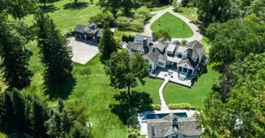 far hills country mansion, exterior of mansion in far hills new jersey with impressive landscaping and outdoor stone fireplace
