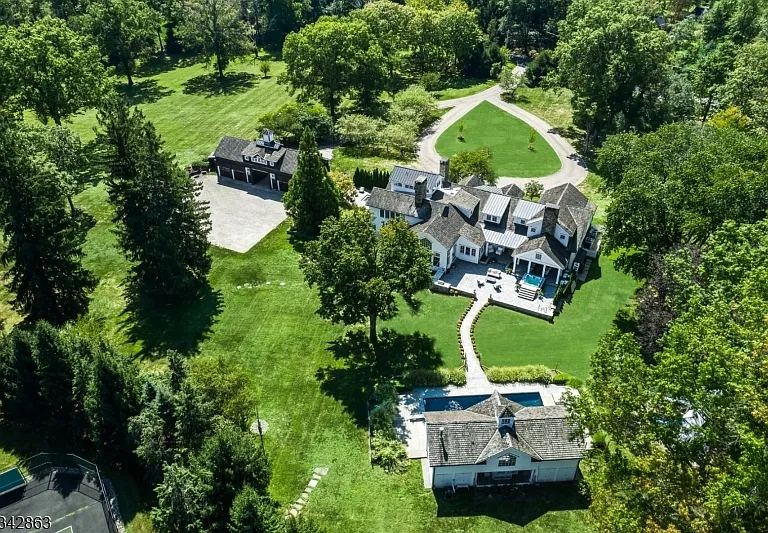 far hills country mansion, exterior of mansion in far hills new jersey with impressive landscaping and outdoor stone fireplace